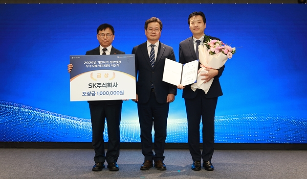 SK AX 관계자가 사내자격 정부공인제도 우수사례 발표대회에서 고용노동부 장관상을 수상하고 기념 촬영하는 장면